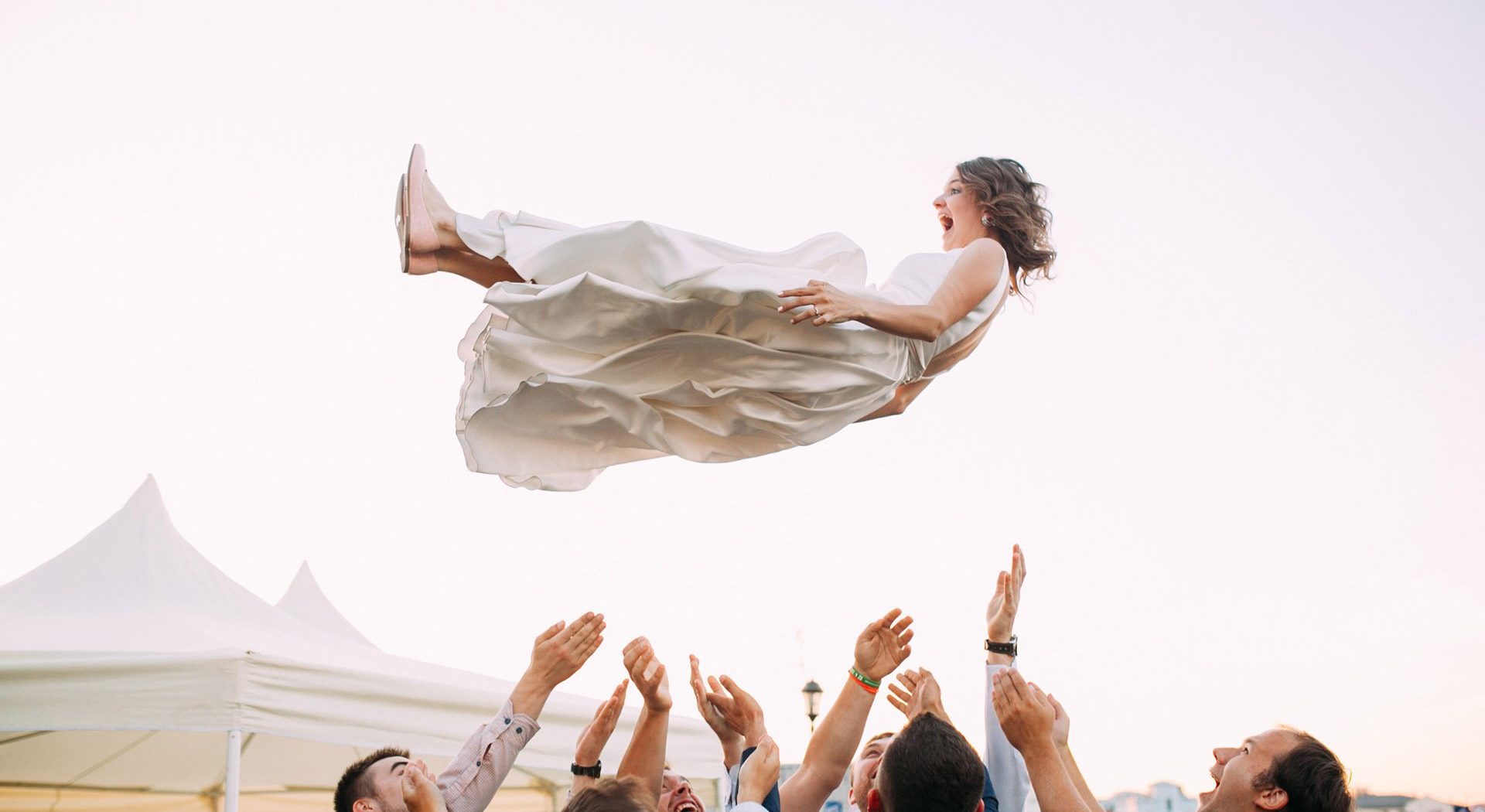 wedding planner throwing bride in the air
